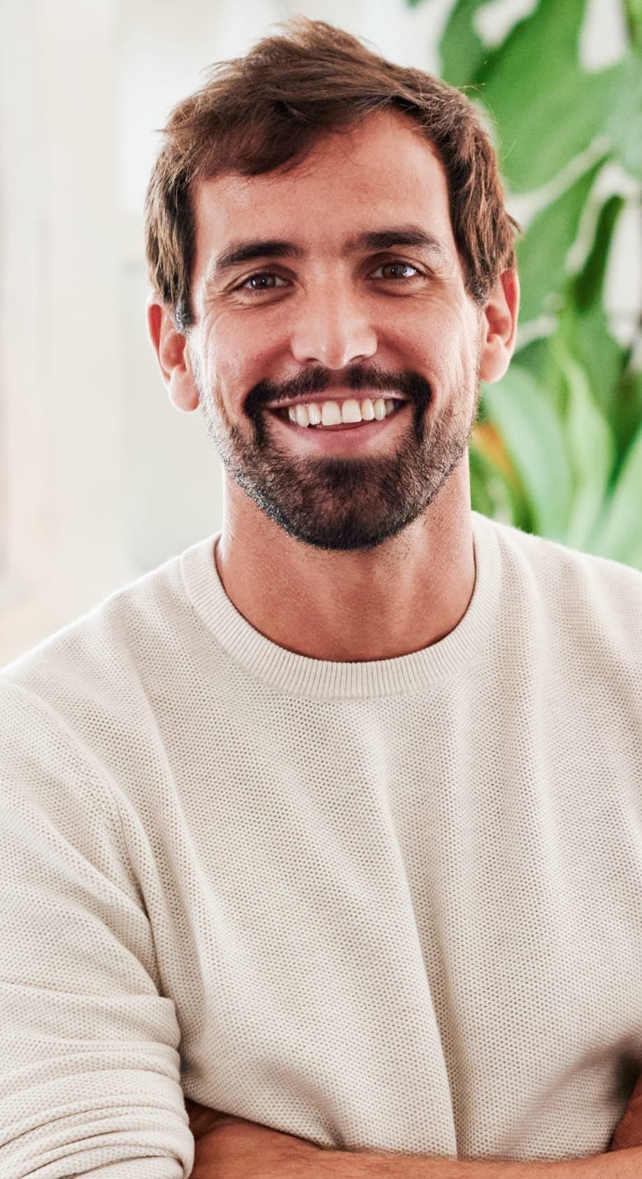 A bearded man smiling warmly